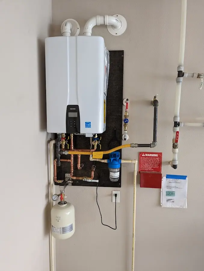 Professional plumber installing copper piping in a Pike Creek Valley home